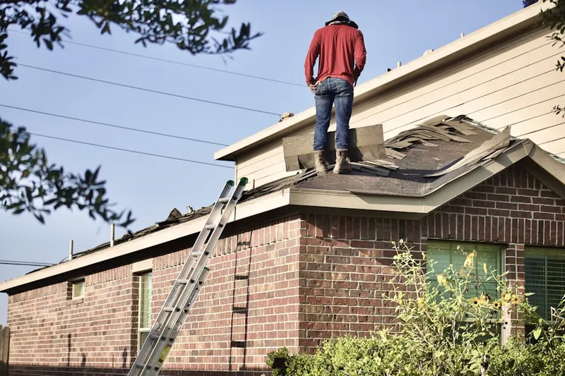 Professional roofer working on a residential roof in Old Quaker Meetinghouse